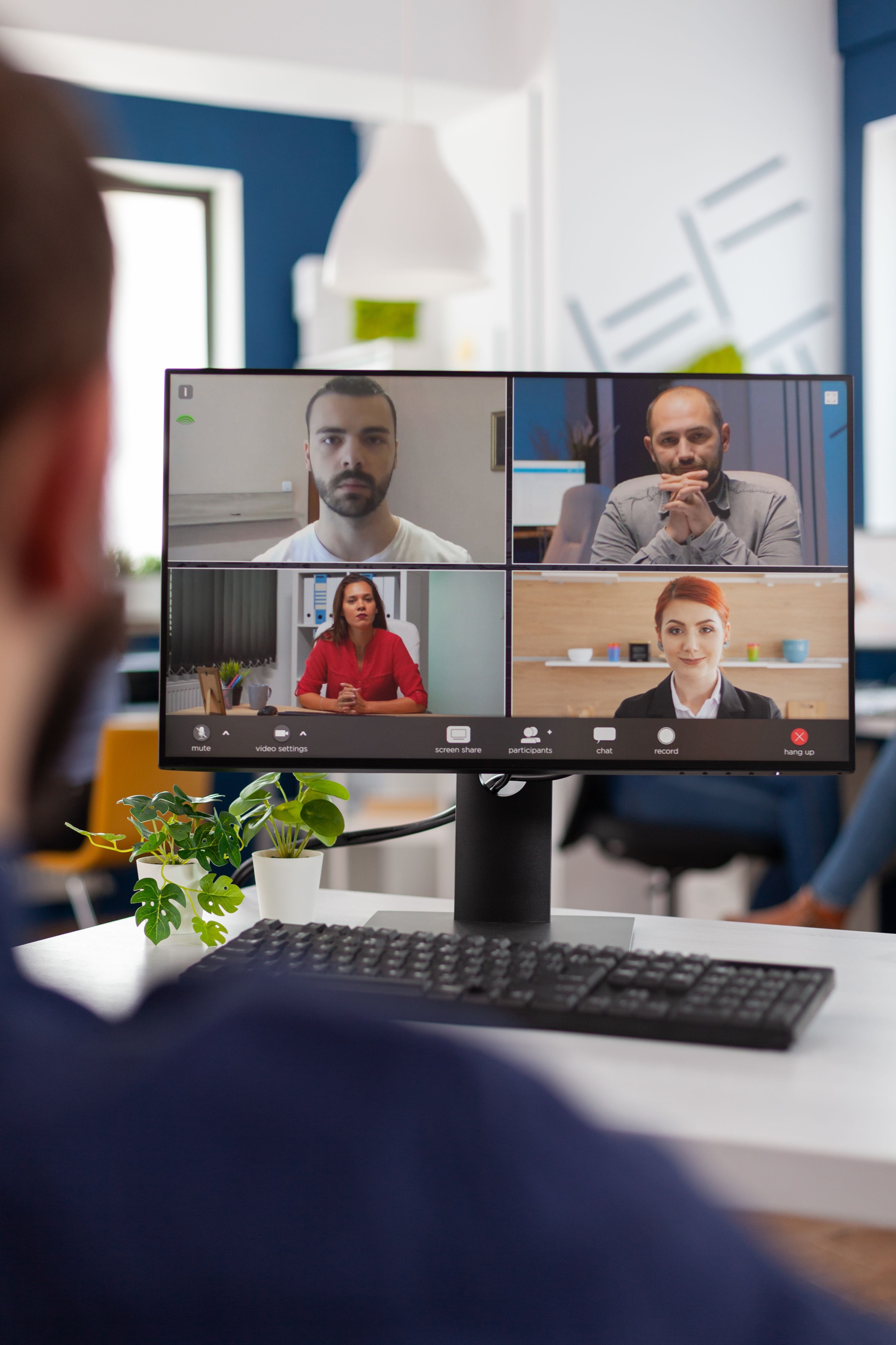 Image of a male executive of color engaged in a focused video call conversation with his leadership coach, exemplifying a dedicated approach to personal growth