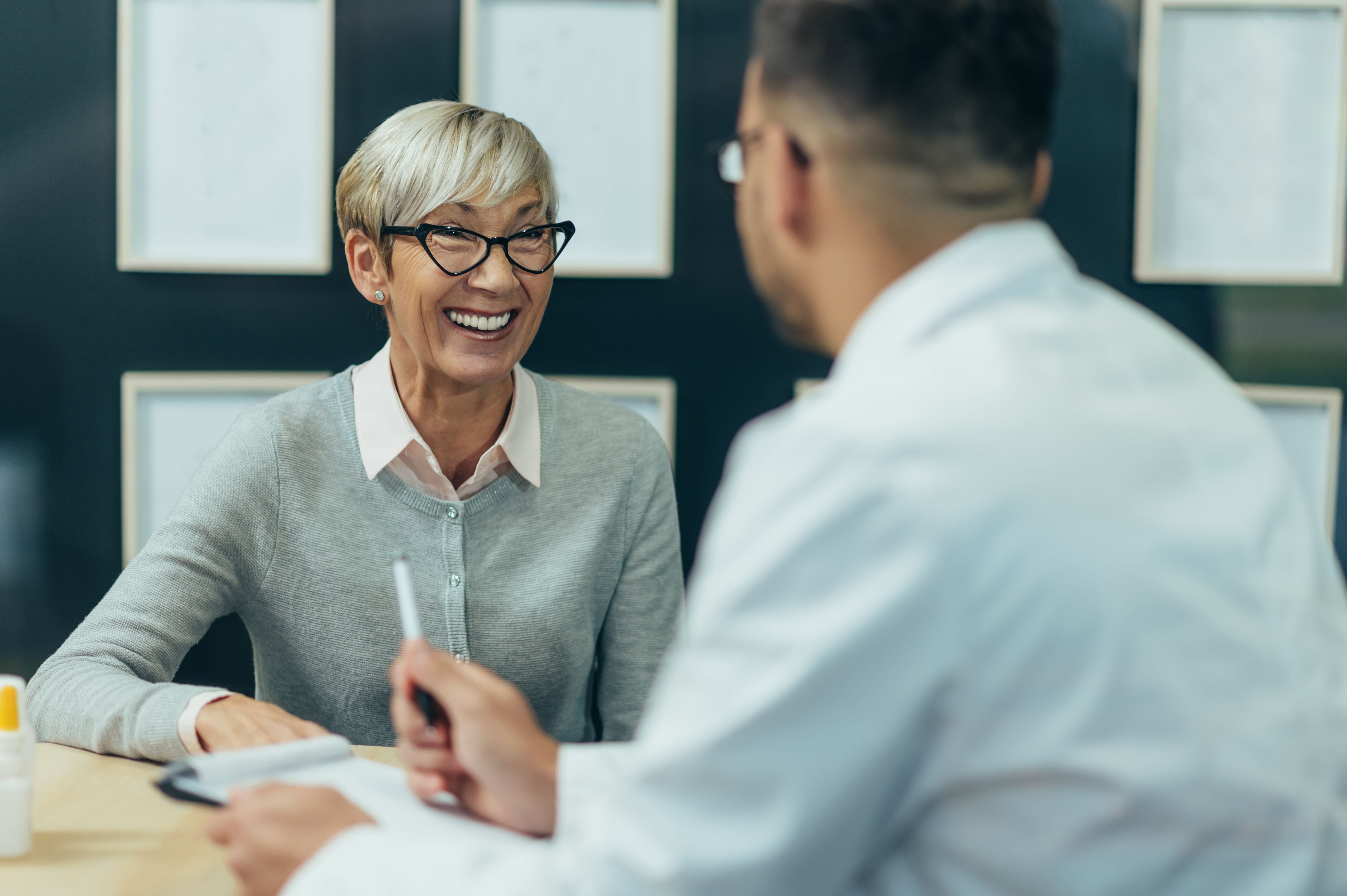 Image showcasing a collaboration between a seasoned female leader and a male leadership coach, emphasizing their partnership in achieving growth and success